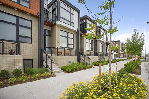 The exterior of a row of modern brown townhomes, where Walters and Company might provide expert Denver property management